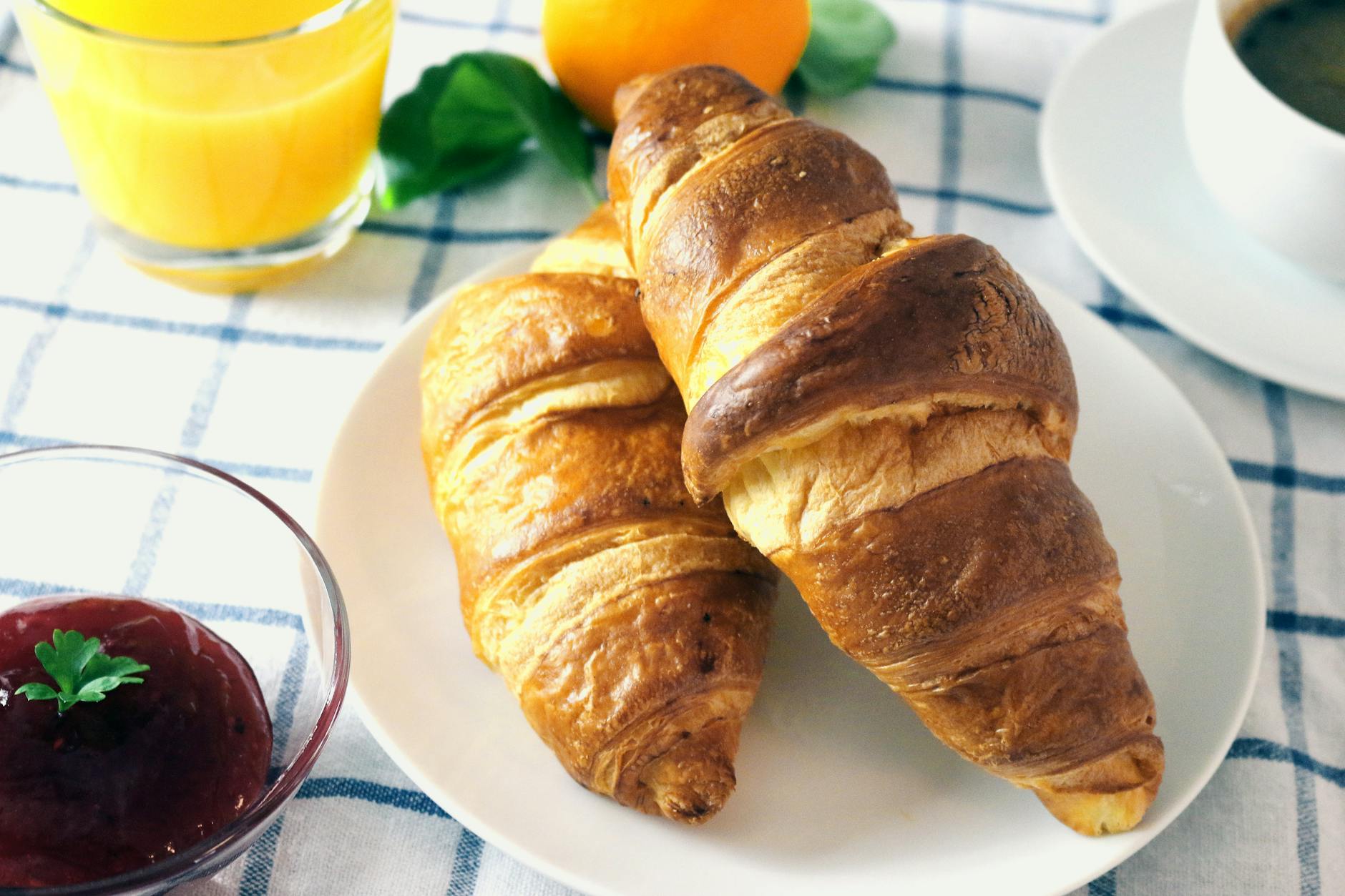 Tasty croissants served with fresh orange juice